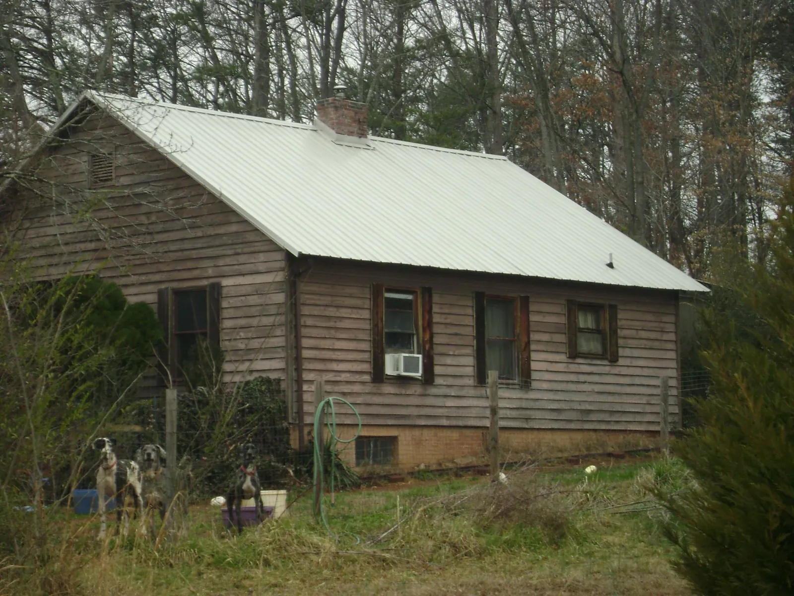 White metal roof on an old wood sided farmhouse, from a Metal Roof Installation job in Gardiner